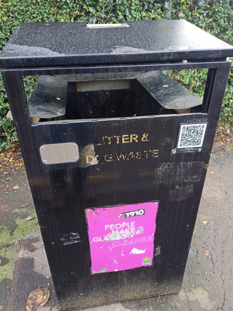 Large council bin at the footbridge, with QR code on the side